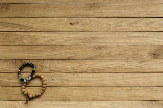 old boards of oak. in the lower left corner is a rosary . suitable for background.