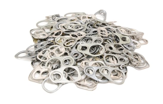 Pile of discarded metal ring pulls from drink and food cans, on a white background