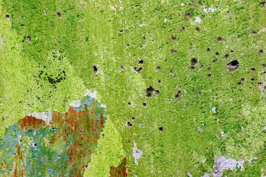 Green repair wall with bullets shoot holes backdrop. Rough housework wallpaper design background. Color room interior decoration texture template