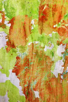 Red and green wall before repair. Rough housework wallpaper design backdrop. Color room vertical interior decoration texture template background
