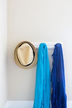 Wall in House with Hat and Scarfs Hanging on Coat Rack Hooks Abstract.