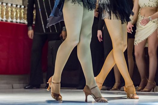 female legs of young girls who dance in competition