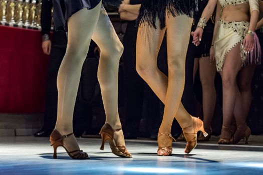 female legs of young girls who dance in competition