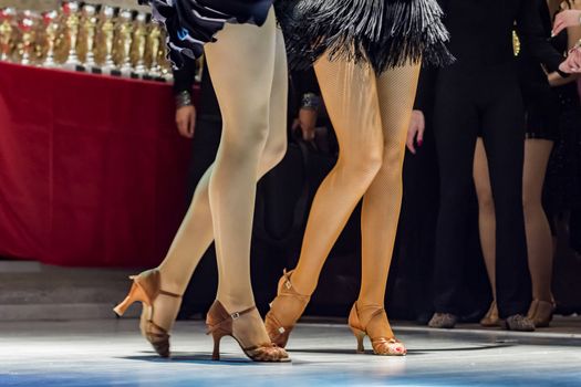 female legs of young girls who dance in competition