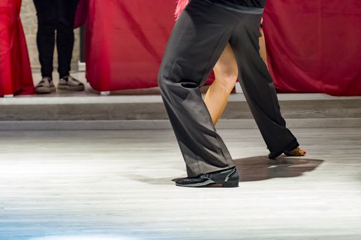 legs of a couple who dance in competition