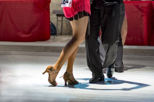 legs of a couple who dance in competition