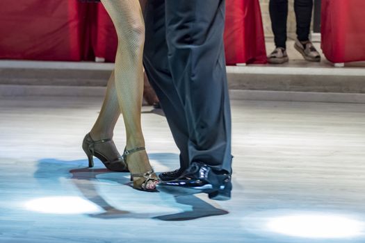 legs of a couple who dance in competition