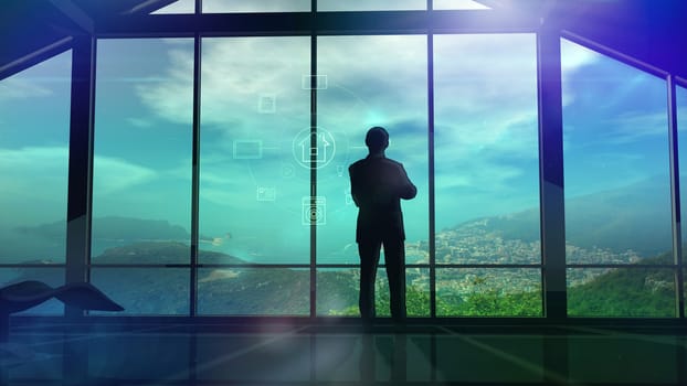 Silhouette of a man in a huge office in front of large windows.