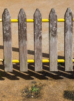 Part of a fence made of wood in view