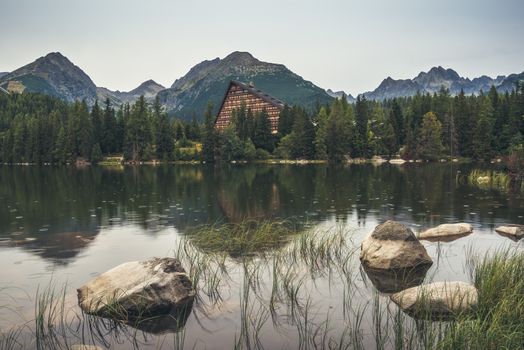 Strbske Pleso Mountain Lake in High Tatras Mountains, Slovakia with Rocks and Grass in Foreground in the Rain