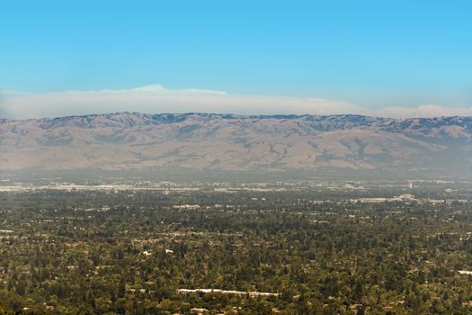 South San Francisco Bay, also called Silicon Valley, with visible smog above the area on a sunny day. The part we see on the image is south San Jose.