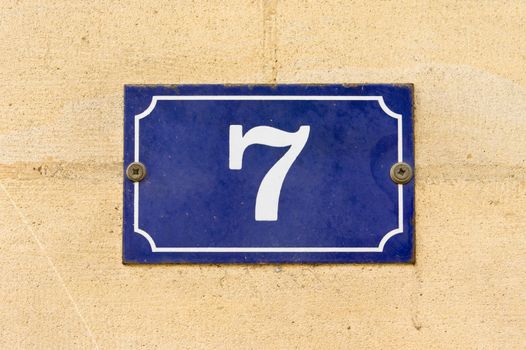 Enameled house number seven (7)