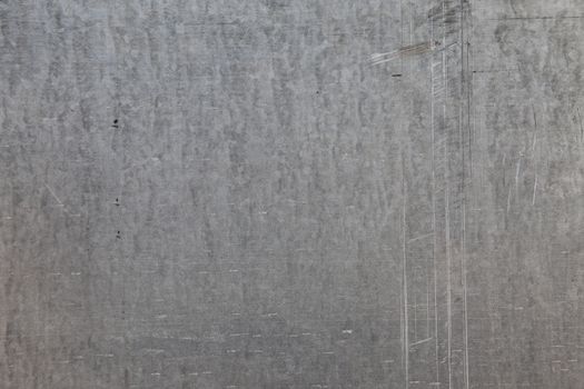 Close-up of a galvanized sheet metal with scratches, background with copy space