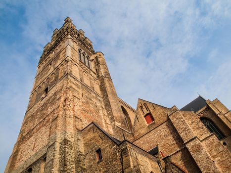 Bottom view of high tower of St. Salvator's Cathedral in Bruges, Belgium