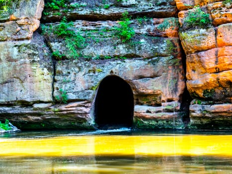 Old rock canal of river Ploucnice in sandstone wall near Straz pod Ralskem in Czech republic.