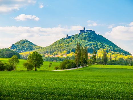 Medieval castle Bezdez on the mountain top. Sunny summer day with lush green fields in Czech landscape. Czech Republic.