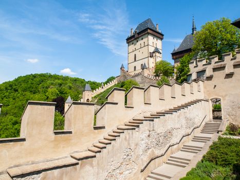 Karlstejn Royal Castle, medieval gothic castle with fortification walls on sunny summer day. Czech Republic