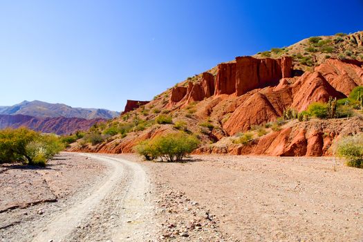 Western-like landscape with red rock formations in dry Quebrada de Palmira near Tupiza, Bolivian Andes, South America.