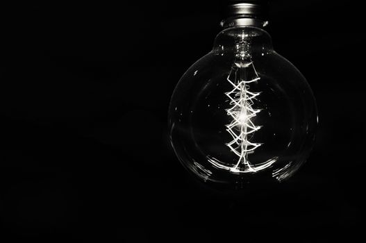 white electric light or bulb on a black background. a photo