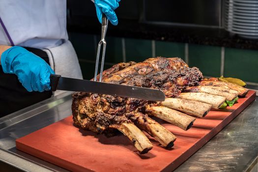 Chef Carving prime rib of  roast Wagyu beef 