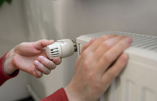Woman Adjusting Thermostat in house