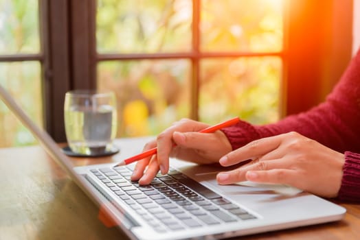 Soft focus Closeup woman hand working on her laptop. Social networking technology concept.