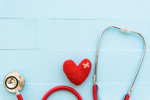 World health day, Healthcare and medical concept. Red heart with Stethoscope, notepad or notebook, thermometer and yellow Pill on Pastel white and blue wooden table background texture.