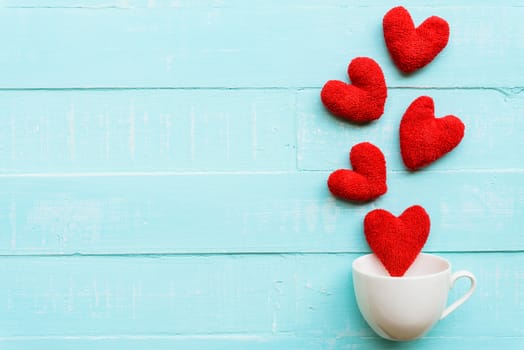 Top view  of handmade pink and red heart on blue and white color wooden background with pastel vintage style. Broken hearted, Love, Wedding and Valentines day concept.