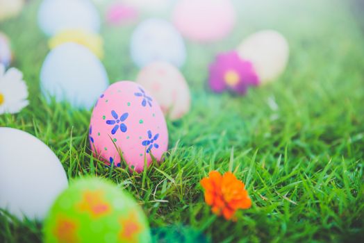 Happy easter!  Closeup Colorful Easter eggs on green grass field background.