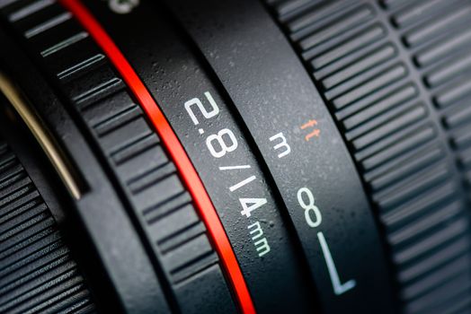 Macro shot of a camera lens focusing on camera lens information.