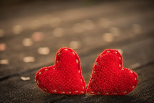 Two red heart with a lot of wooden hearts on wooden background with vintage style. Broken hearted, Love forever, Wedding and Valentines day concept.