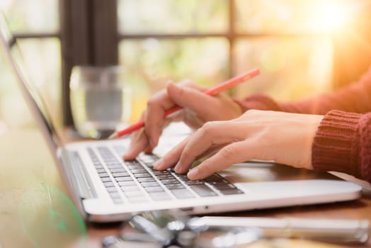 Soft focus Closeup woman hand working on her laptop. Social networking technology concept.