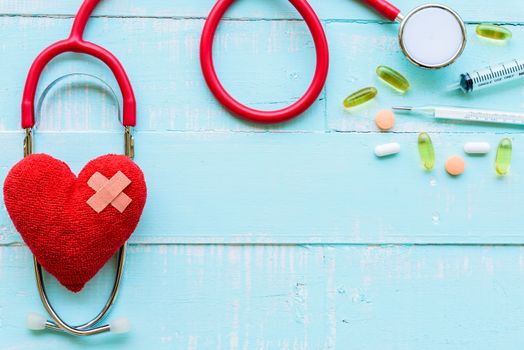 World health day, Healthcare and medical concept. Stethoscope, red heart, notepad or notebook, thermometer and yellow Pill on Pastel white and blue wooden table background texture.