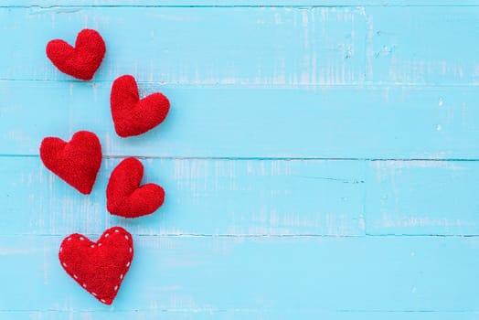 Top view  of handmade pink and red heart on blue and white color wooden background with pastel vintage style. Broken hearted, Love, Wedding and Valentines day concept.