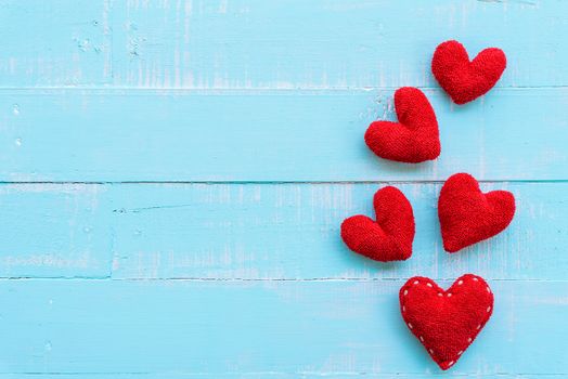 Top view  of handmade pink and red heart on blue and white color wooden background with pastel vintage style. Broken hearted, Love, Wedding and Valentines day concept.