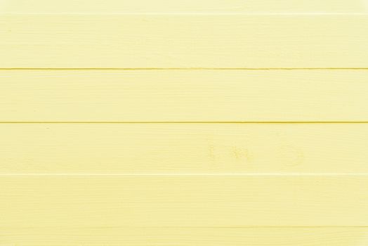 Pastel bright yellow wooden table background texture.