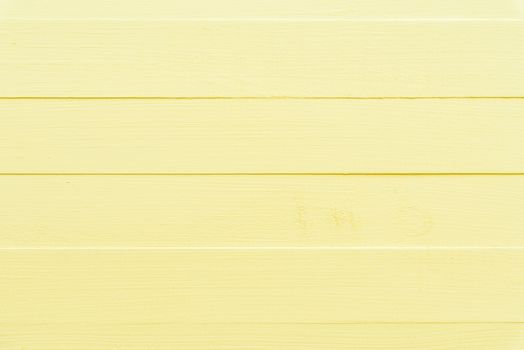 Pastel bright yellow wooden table background texture.