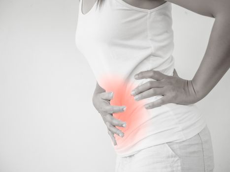 Woman having a stomachache, or menstruation pain with white background. Health care and medical concept.