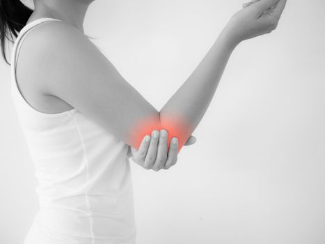 Close up woman having pain in injured elbow. Health care and arm pain concept.