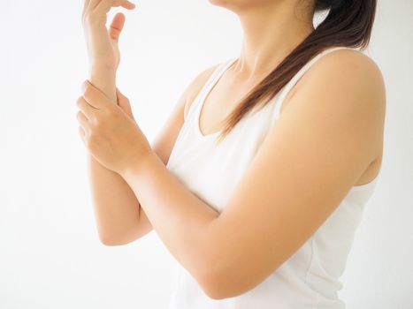 Close up young woman holding her wrist symptomatic Office Syndrome. Healthcare and arm pain concept.