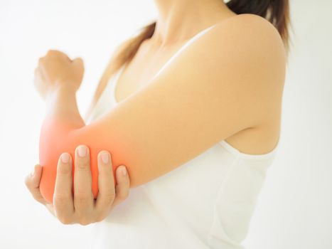 Close up woman having pain in injured elbow. Health care and arm pain concept.