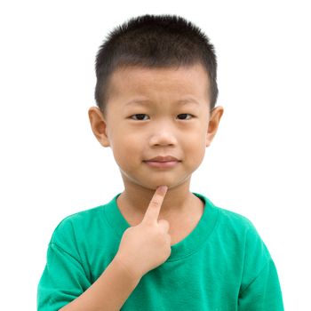 Happy Asian child pointing his chin and smiling. Portrait of young boy showing body parts isolated on white background.
