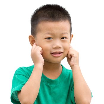Happy Asian child pointing his ears and smiling. Portrait of young boy showing body parts isolated on white background.