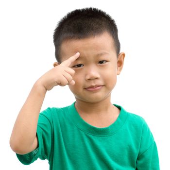 Happy Asian child pointing his eyebrow and smiling. Portrait of young boy showing body parts isolated on white background.