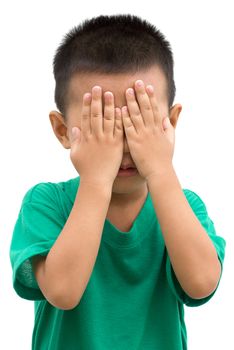 Asian child covered eyes with hands. Portrait of young boy isolated on white background.