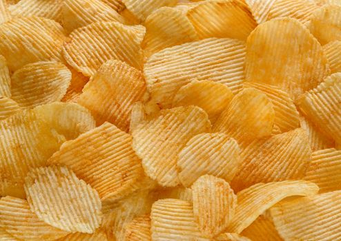 background of potato chips golden yellow