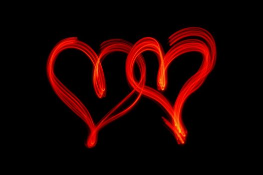 couple of red hearts on black background