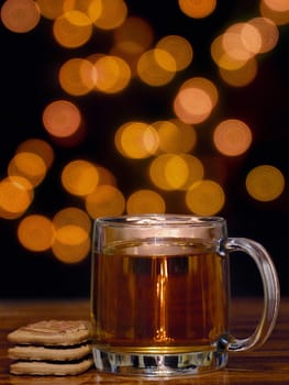 cozy cup of tea with cookies and bokeh background