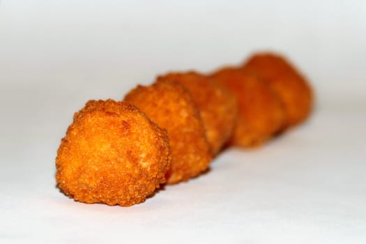 fried potato balls on white background