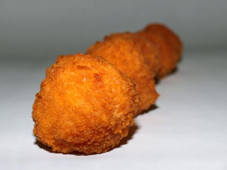 fried potato balls on white background